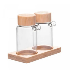 Imagem de CONJUNTO 2 GALHETEIROS DE VIDRO BOROSSILICATO COM TAMPA E SUPORTE DE BAMBU 170ML - Rojemac Impotacao E Exportacao Ltda